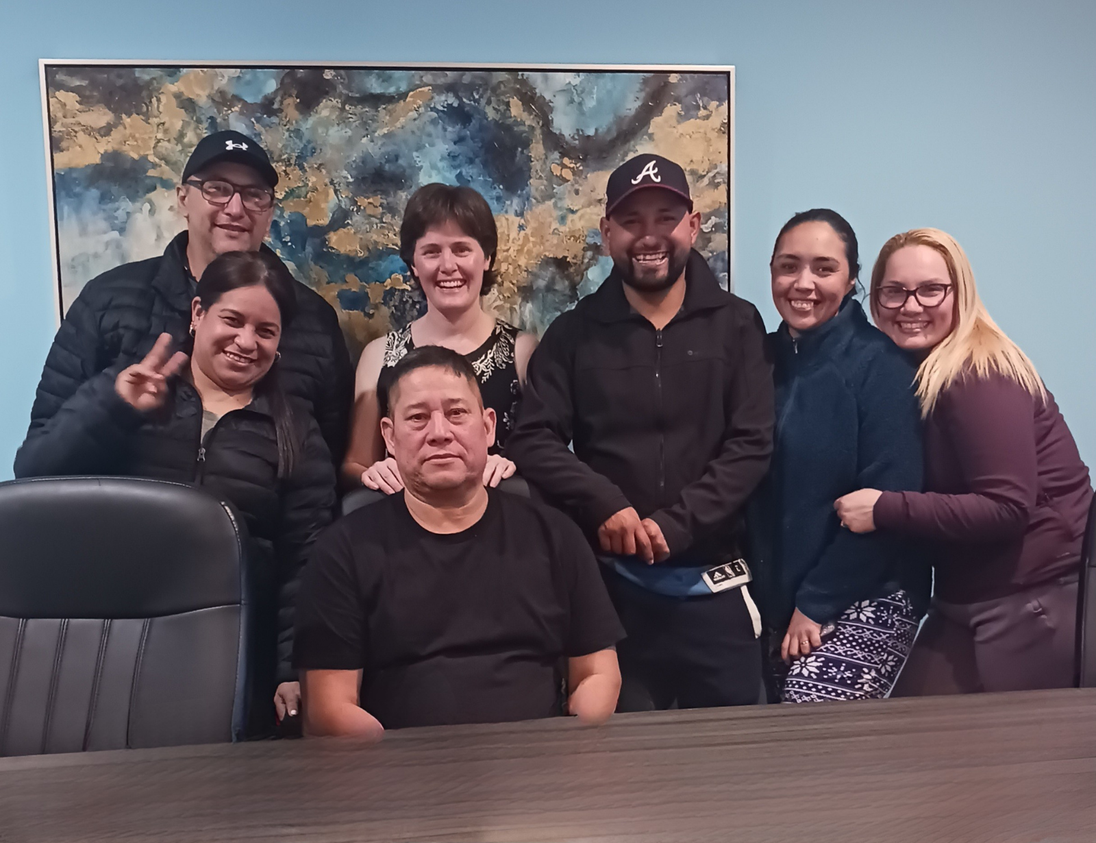 A diverse New Heights Languages worker group with their instructor